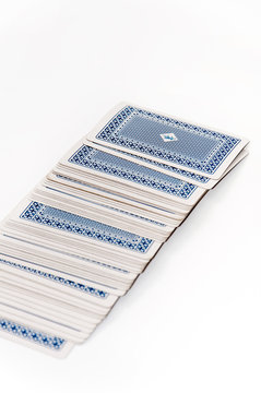 Spilled blue playing cards over white