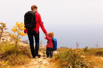 mother and little daughter travel in mountains