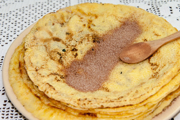 Sugar with grounded cocoa on the pancakes