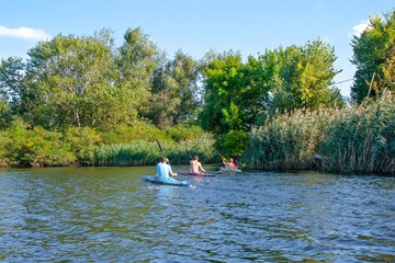 boys paddle canoes on the river