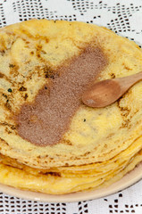 Sugar with grounded cocoa on the pancakes