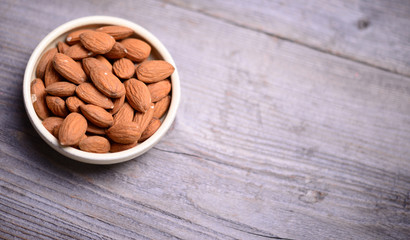 Almonds on wooden background