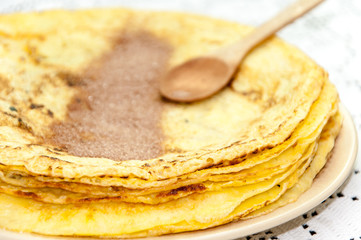 Sugar with grounded cocoa on the pancakes