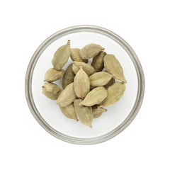 Top view of Organic Green or True cardamom (Elettaria cardamomum) half filled in glass bowl isolated on white background.
