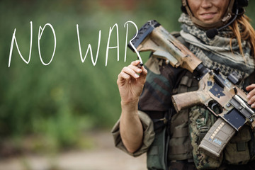 woman soldier writes marker on transparent glass