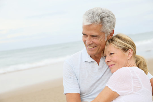 In love senior couple embracing at the beach