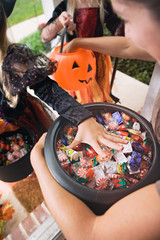 Halloween: Girl Grabs For Halloween Candy From Bucket