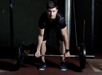 Naklejka na ściany i meble Athlete Fitness trainer working out / weight lifting in a gym
