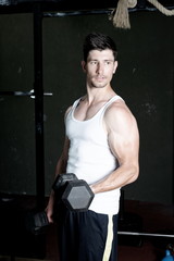 Fototapeta na wymiar Fitness Trainer training his biceps at the gym