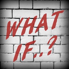 The question What If? in red text on a brick wall background processed in black and white for effect