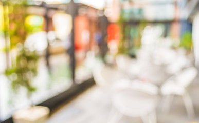 blur image of out door restaurant with green garden in backgroun