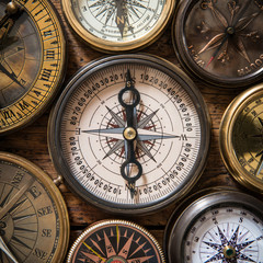 Old compass on vintage wood