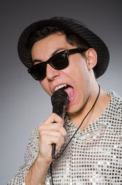 Young Man In Silver Shirt And Microphone Isolated On White