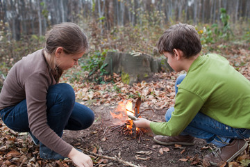 Children starting a campfire