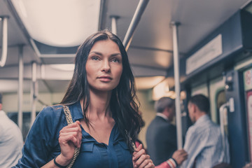 Beautiful girl posing in a metro car