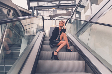 Beautiful girl posing on an escalator