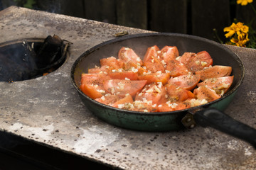 Tomatoes grilled over an open fire with garlic and pepper