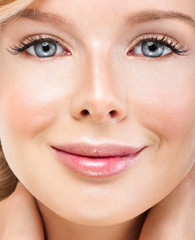 Obraz premium Beautiful face of young adult woman with clean fresh skin. Looki
