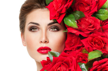 Beautiful woman face surrounded by red roses. Perfect skin. Prof