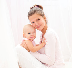 Mother and baby playing and smiling. Happy family.Home interior.