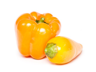 whole two orange paprika (peppers) isolated on a white background.