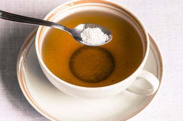 Tea with sweetener in a spoon