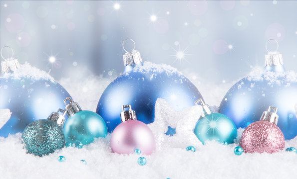 Christmas background with blue baubles,snow and snowflakes, free space for text. Christmas decoration. 