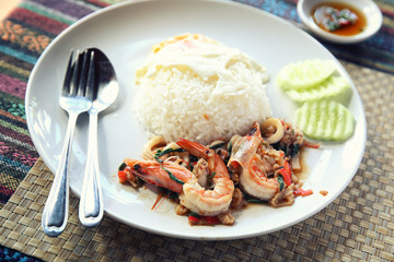 Sea food with basil and egg served with rice