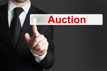 businessman pushing button auction