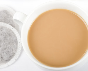 Cup of Tea - Simple cup of tea with milk and tea bags on a white background shot from above.