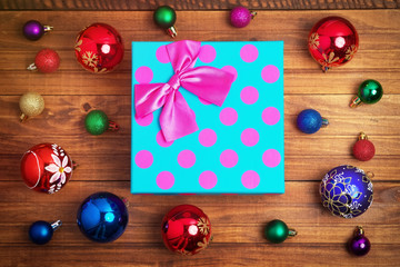 Christmas gift and different christmas toys on wooden background