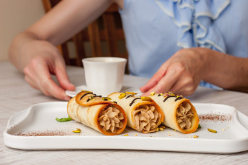 Woman drink coffee with Sicilian cannoli
