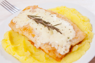 fish fillet under cheese with mashed potatoes