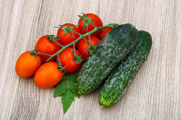 Cucumbers and tomatoes on the branch
