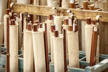 Wooden stand with ancient rolled maps