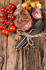 Delicious beef steak on wooden table. Fresh beef meal and grilled vegetable 