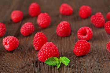 Fresh red raspberries on wooden table, closeup