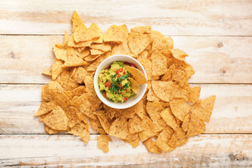 Nachos with Guacamole on wooden background