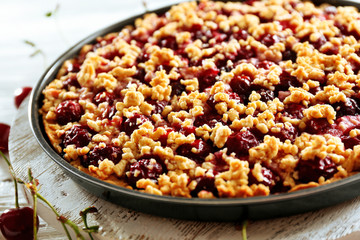 Tasty homemade pie with cherries on table close up