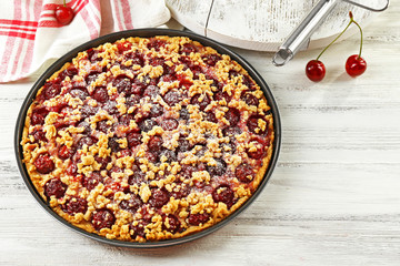 Tasty homemade pie with cherries on table close up