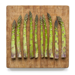 Asparagus on bamboo cutting board