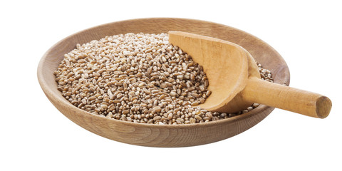 wheat seeds in wooden bowl and a wooden spoon