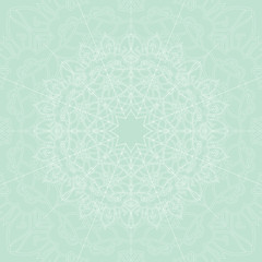 Ornamental vector mandala on the light green background.