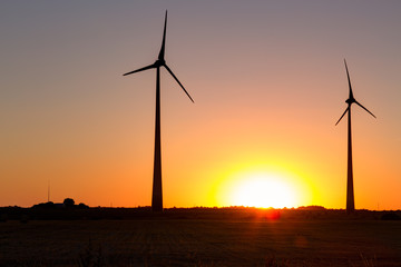 Wind power plant during sunset time. Lithuania.