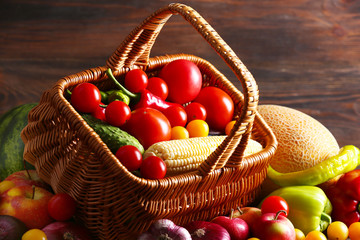 Heap of fresh fruits and vegetables on wooden background