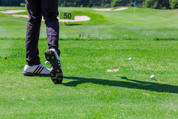 Low section of golf player ready to hit the ball