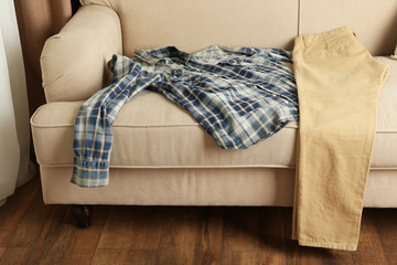 Male clothing on sofa in room