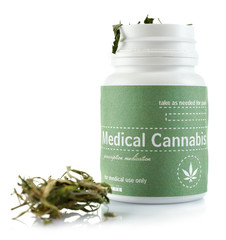 Bottle of dry medical cannabis isolated on white