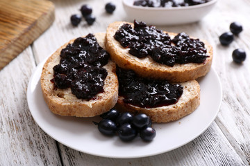 Fresh toast with butter and jam on table close up