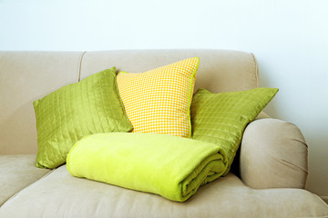 Fototapeta na wymiar Colorful pillows on sofa, close-up
